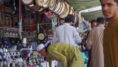 islamabad market comes alive with people energetically bargaining and buying for the products and groceries from numerous street vendors and stalls