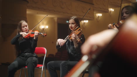 violin-and-viola-in-small-orchestra-female-musicians-are-playing-music-classic-music-concert-or-rehearsing