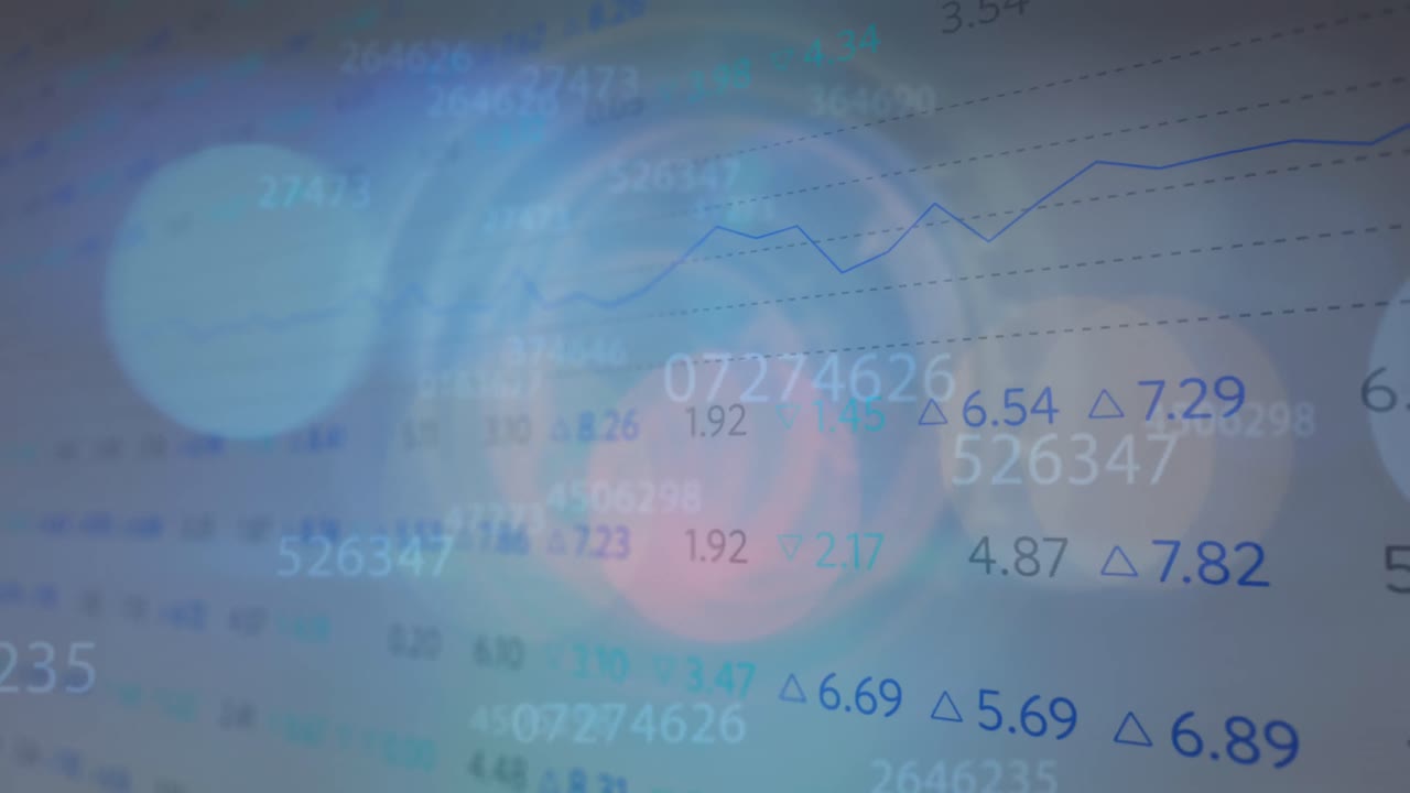Spots of light and multiple changing numbers against stock market data processing
