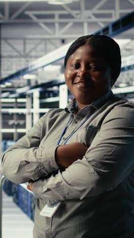 vertical video portrait of smiling it professional in server farm optimizing machine learning