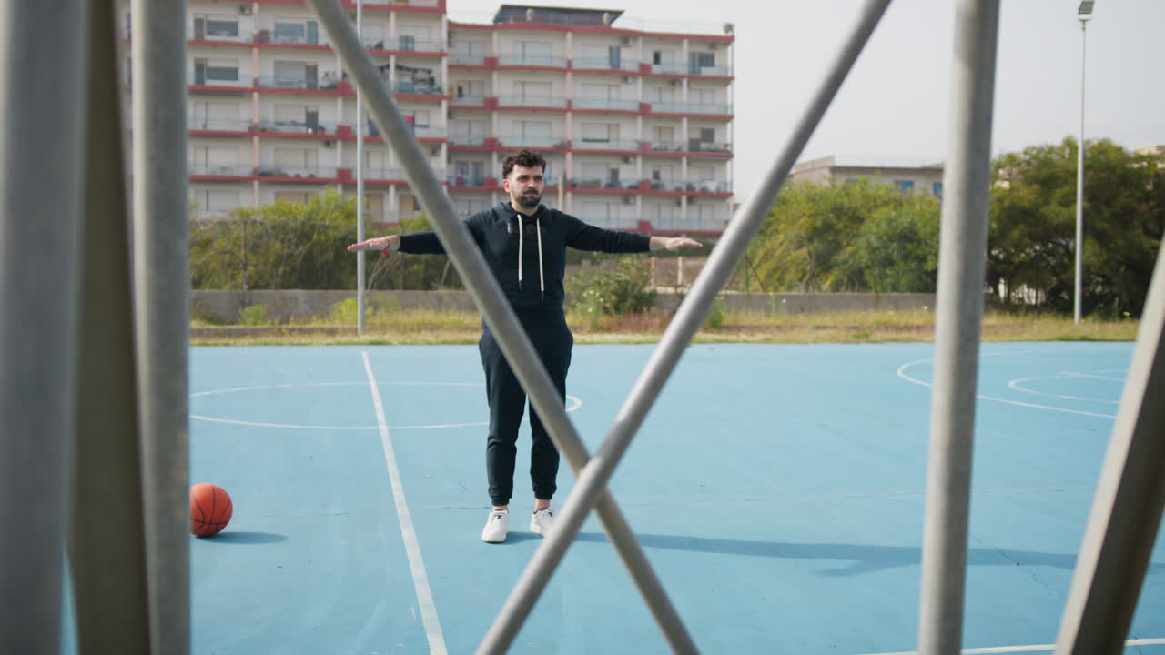 Man Practicing Basketball on Outdoor Court
