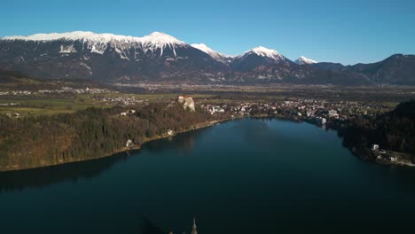 aerial pullback reveals amazing lake bled, slovenia in winter