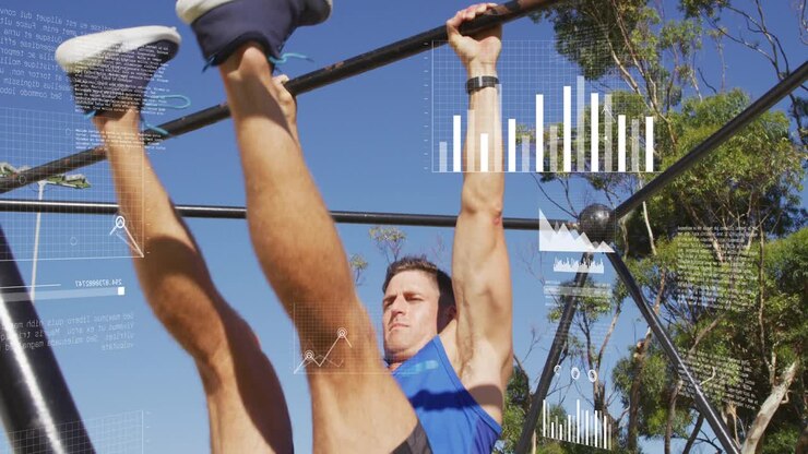 Man hanging on bar after HUD graphics rising lifting legs for fitness while charts overlaying torso