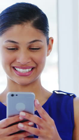 woman smiling using smartphone