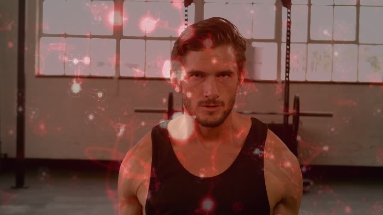 Man lifting hex dumbbells and doing biceps curls in gym for strength, red particles overlaying