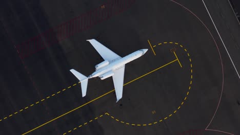 above parked white gulfstream private airplane on concrete tarmac