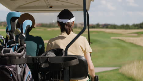 caucasian woman and african american man on the golf course.