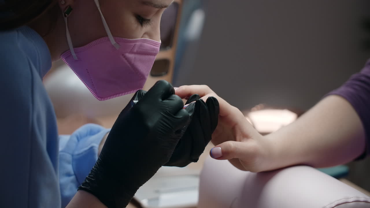 Woman getting her nails done at a nail salon