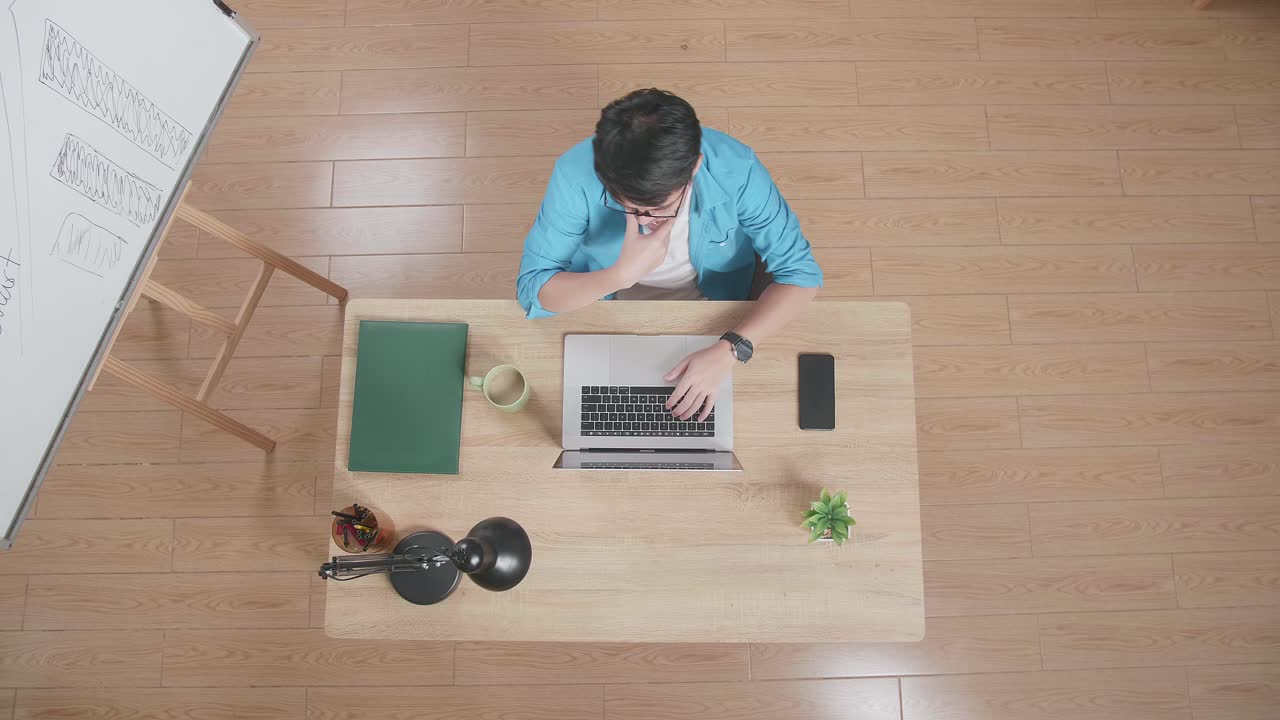 집에 있는 스마트폰 에 있는 노트북에서 화이트보드 에 앉아서 지표손가락을 올리는 아시아 남자의 상단 시상