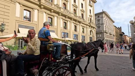 a horse-drawn carriage on a busy street