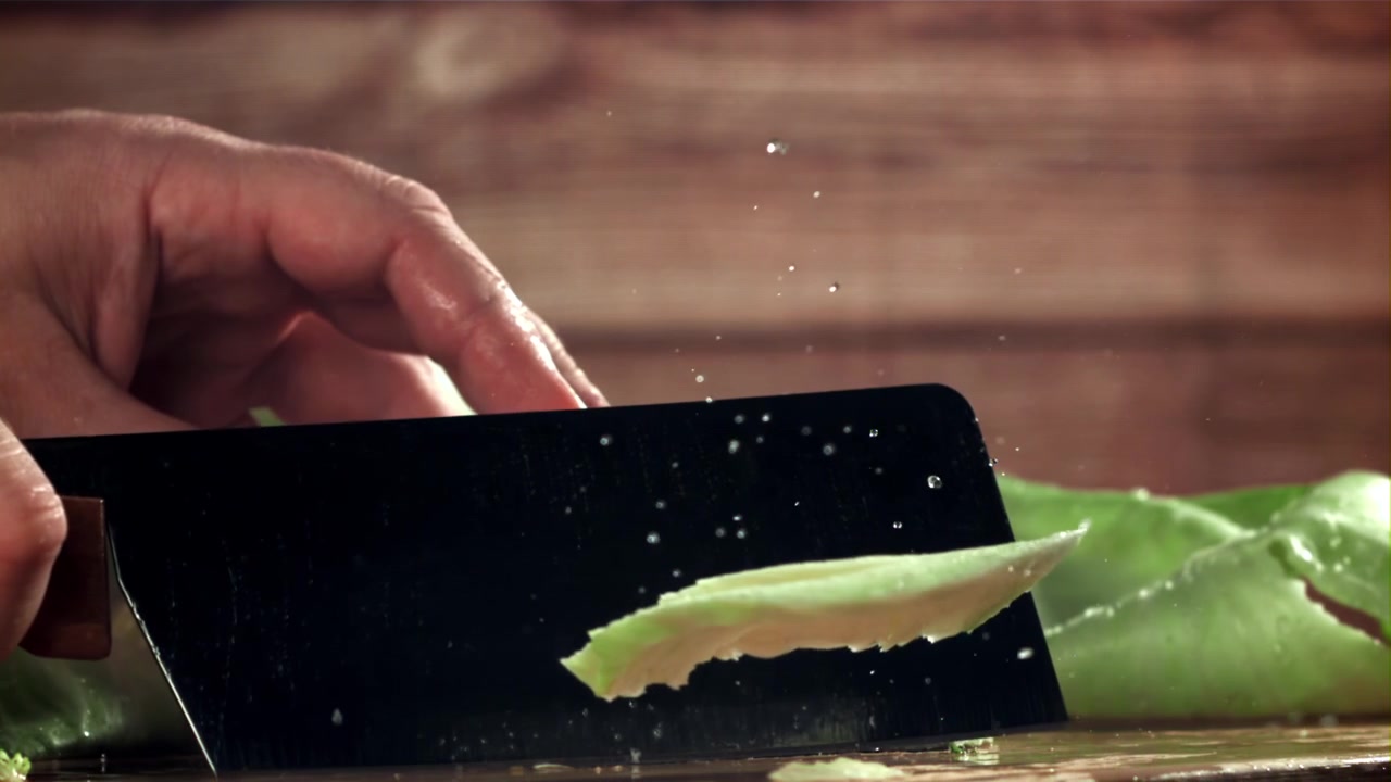 Chef's Hand Slicing Fresh Cabbage in Slow Motion