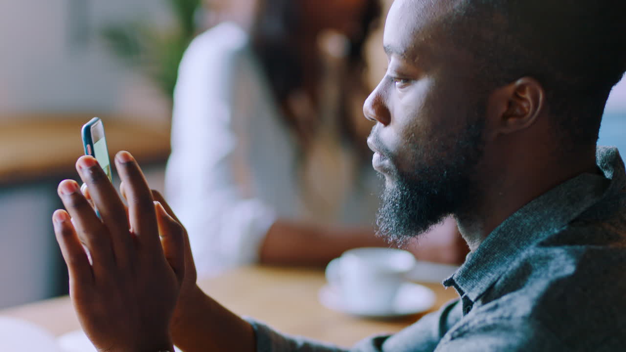 Black man in cafe, phone and typing while on lunch