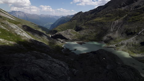 alpine lake water fed directly from the pasterze glacier and the surrounding mountains in the austrian alps, drone shot