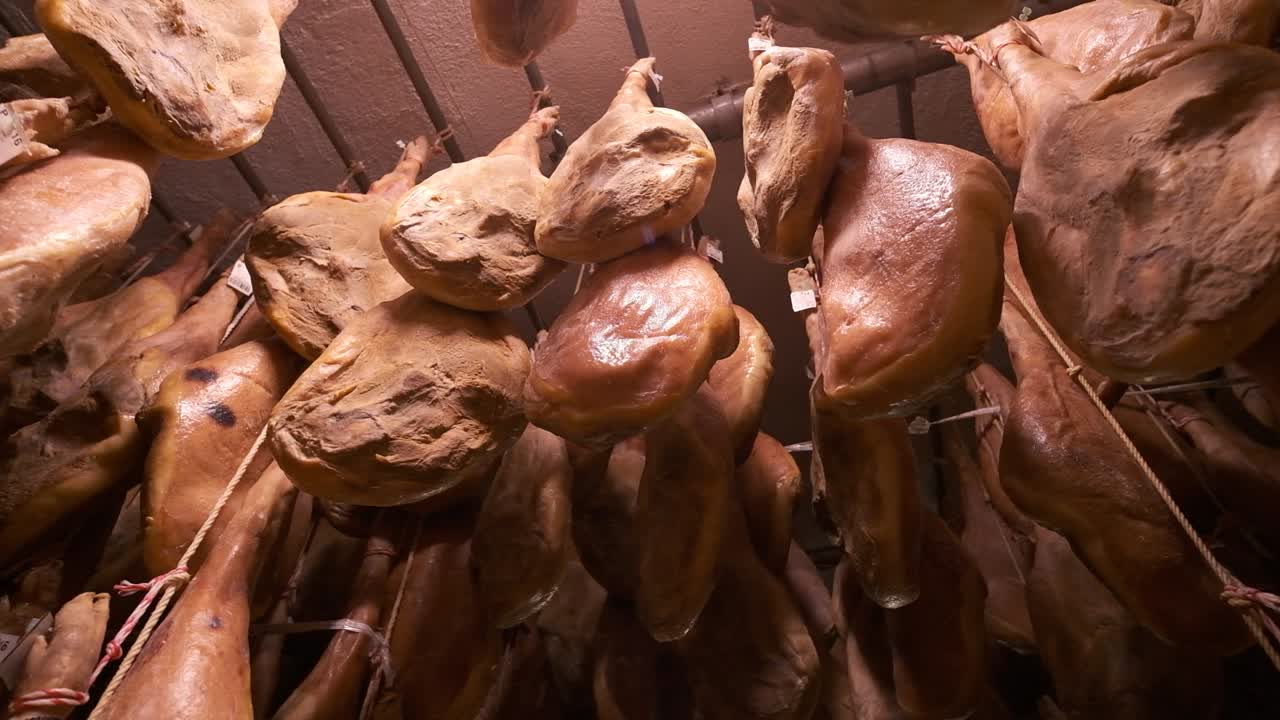 Jamon serrano pig legs factory hanging in a industry. Iberian ham elaboration process