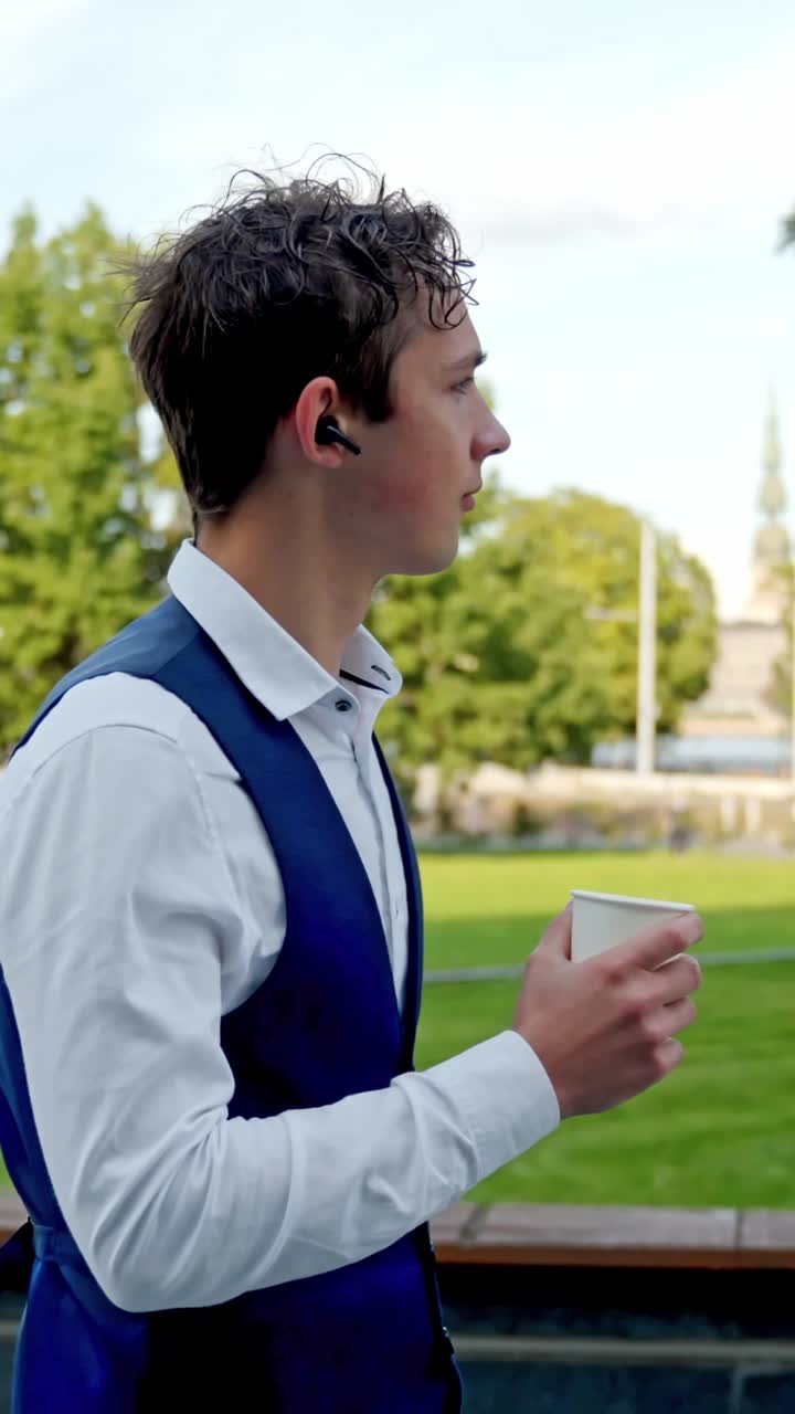 Millennial Career Moment, Confident Businessman with Coffee and Earbud, Vertical