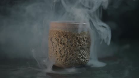 zoom in to the ceramic cup surrounded by smoke