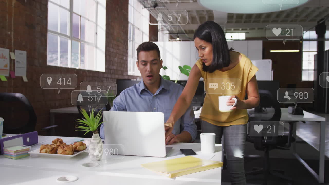 In office, colleagues discussing animation on laptop screen with notifications