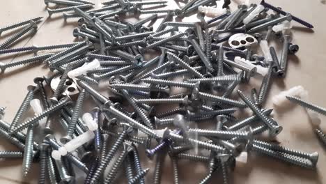 metal fasteners bolts, screw, and nuts fall on the table, close-up, hardware bolt, nut, and screw fall on the table