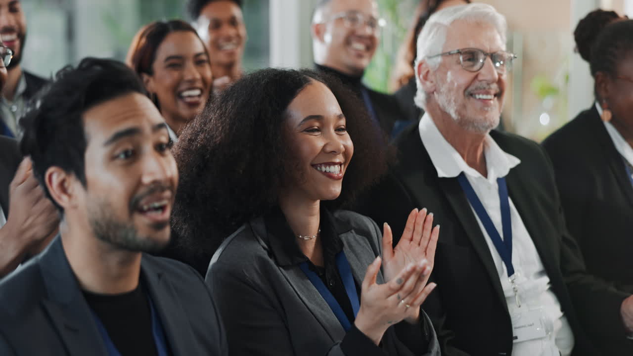 Diverse group of people applauding at a business meeting
