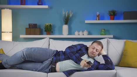 man lying on the sofa is resting.