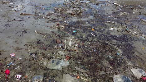 aerial close up of rubbish and debris adrift on a beach