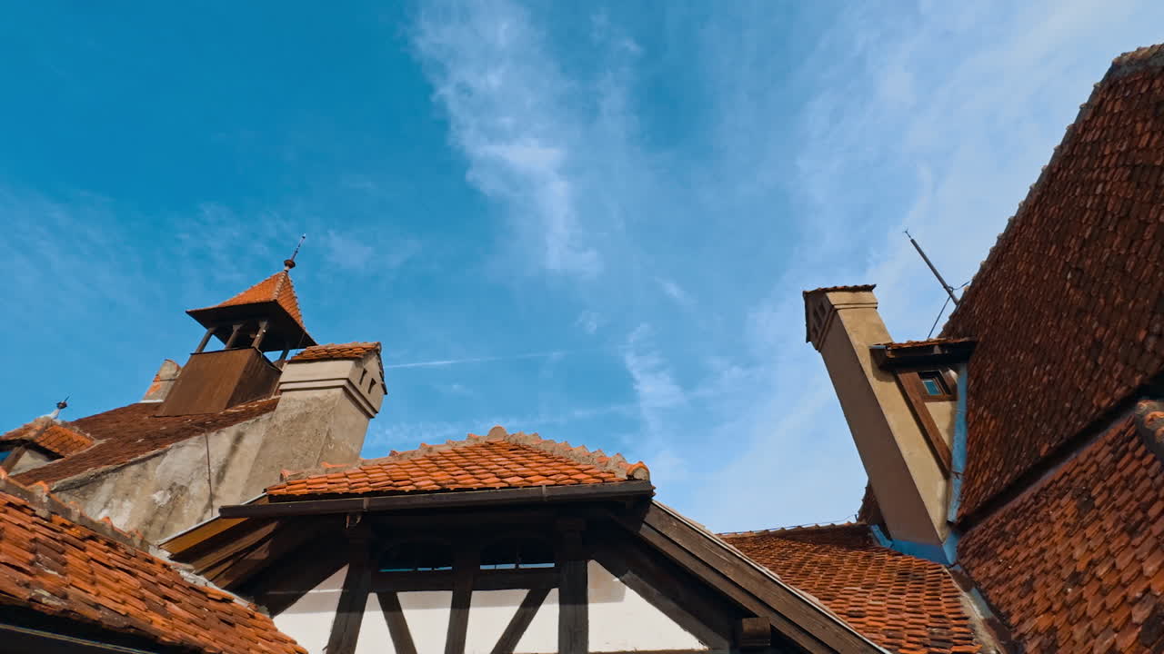 Rooftops of old castle covered with red tiles. Castle Bran of notorious Dracula in Romania. Low angle view.