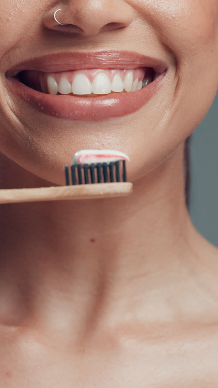 Smiling Person Holding Toothbrush with Toothpaste