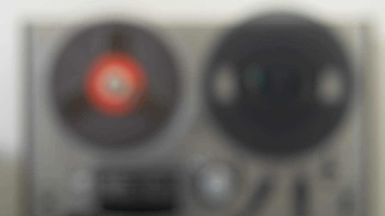 Out of focus Reel to Reel tape recorder, in spinning motion