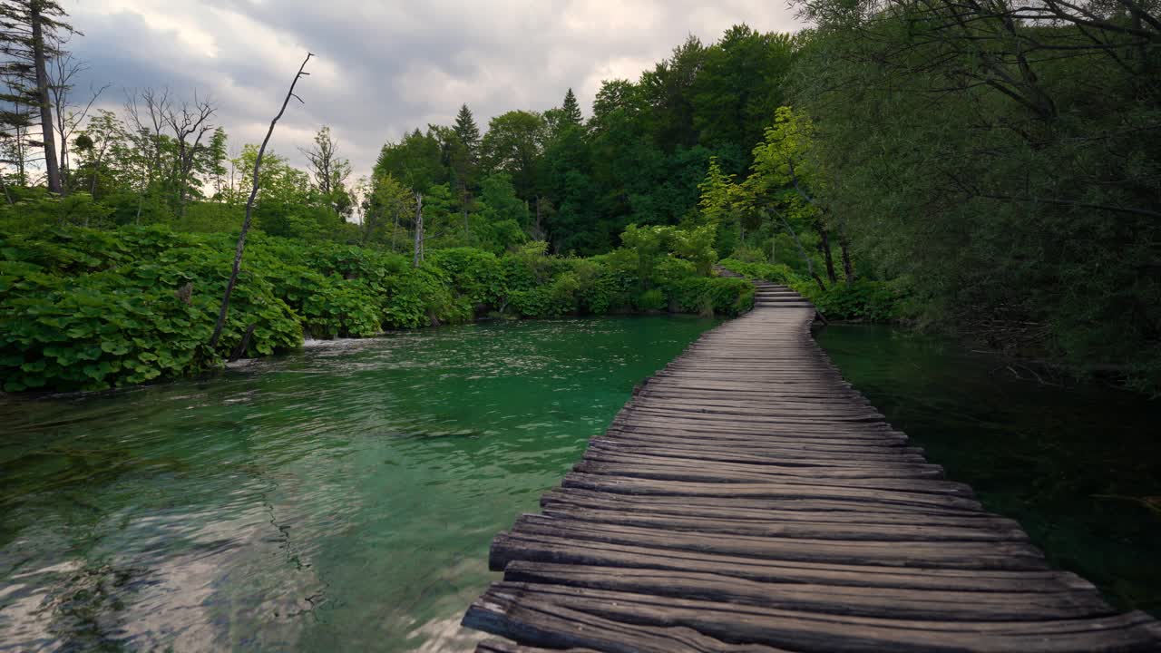 Scenic emerald lakes at Plitvice National Park Croatia UNESCO site with wooden walkways across the water