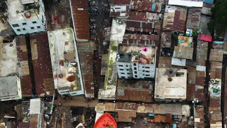 elevating aerial shot of rooftops from a slum or unfavored neighbourhood in bangladesh