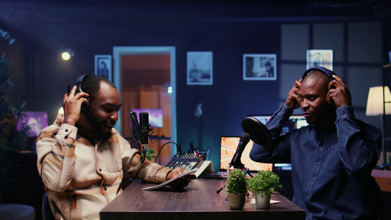 Man on podcast fist bumping presenter, starting marathon stream for humanitarian cause