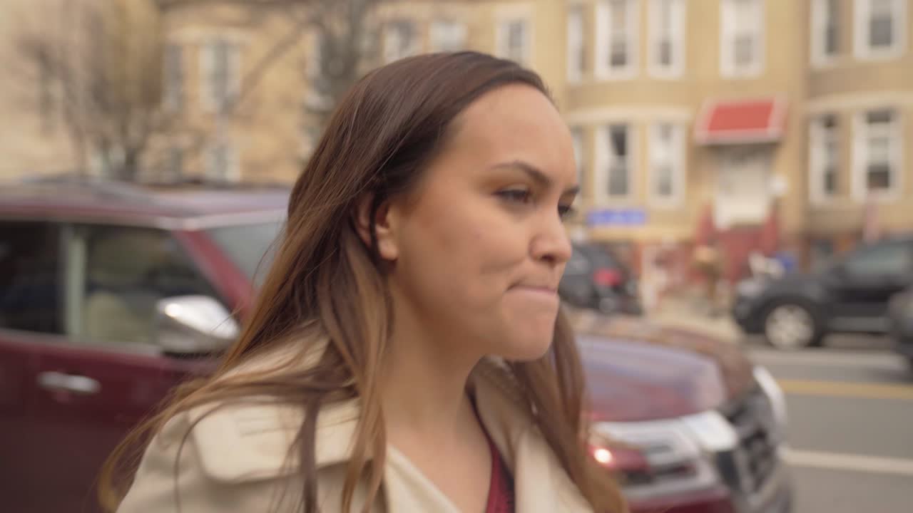 Good looking woman walking down the street in casual business attire