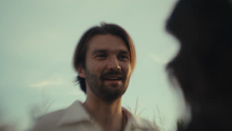 A man happily engaging in conversation outdoors