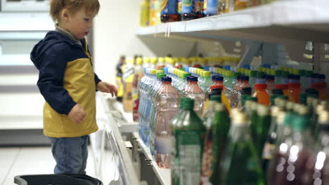 Little-boy-putting-mineral-water-into-the-basket