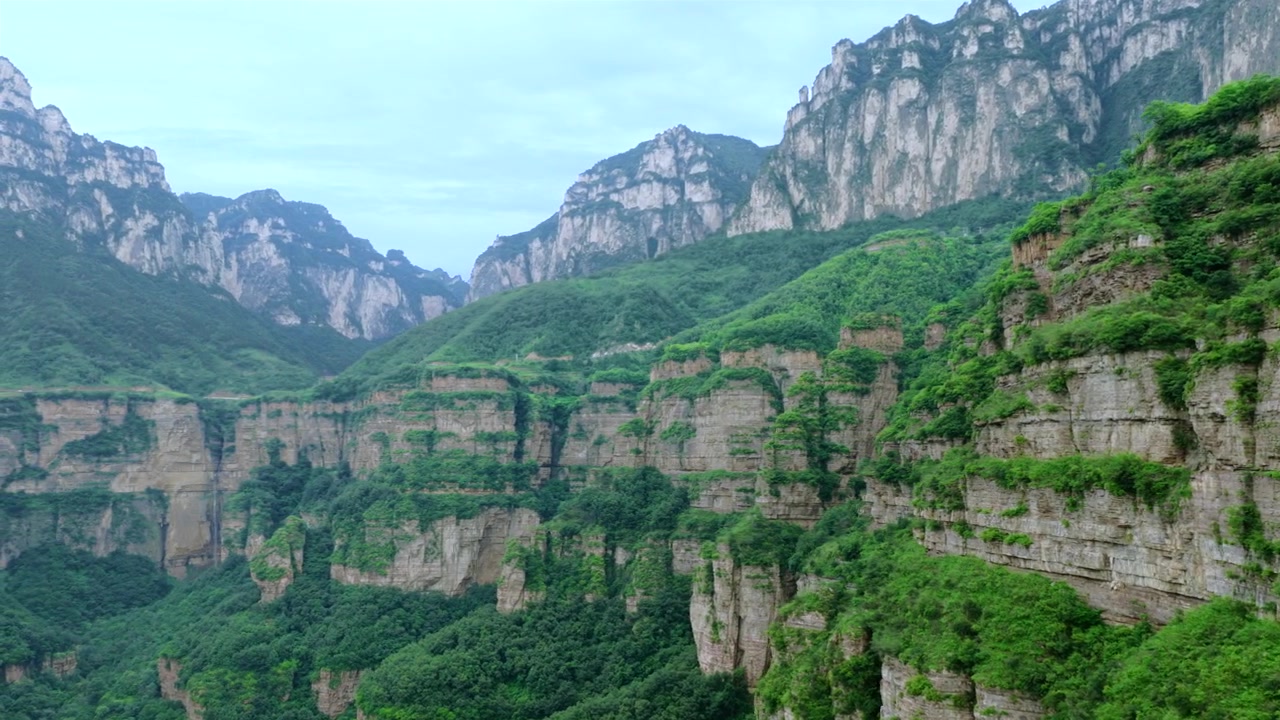 Aerial panorama of magnificent Taihang Mountains grand canyon with steep layered rock cliffs, natural geological landforms in China