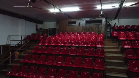 empty theater hall, red bleachers with no spectators