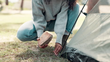 woman setting up tent while camping