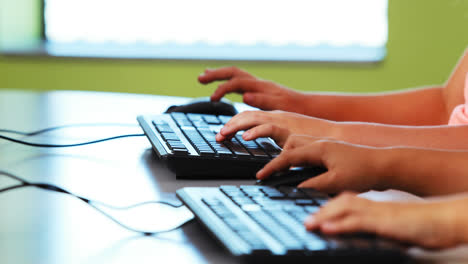 Schoolgirls using computer in classroom