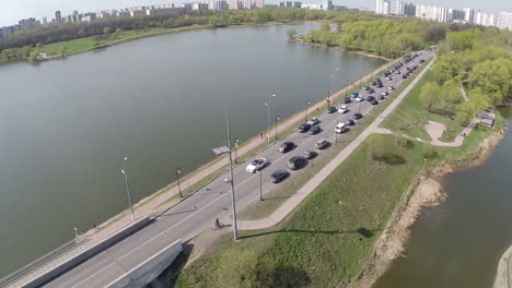 Flying-over-car-traffic-on-waterside-road