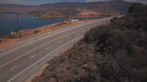 shown from above, team of deputy sheriffs ride past castaic lake in castaic