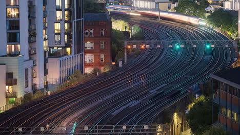 time-lapse of trains in london uk zooming smoothly across mutliple tracks