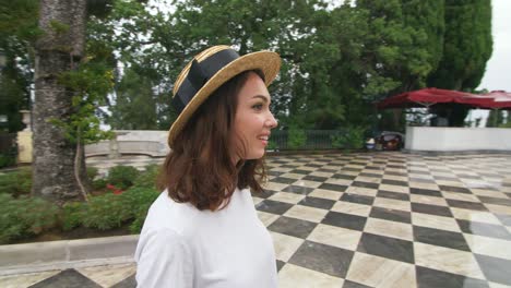 tourist woman standing under rain on antient building background on travel