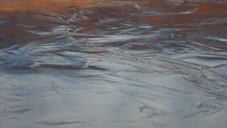 Icy-patterns-form-on-the-surface-of-the-shallow-lake-in-autumn-tundra