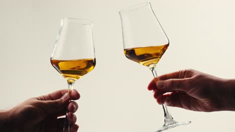 orange or white wine bottle and glass against a sunset in a peaceful vineyard, pouring of ecological natural wine.