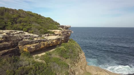 aerial drone shot - flying forward towards a cliff - ocean