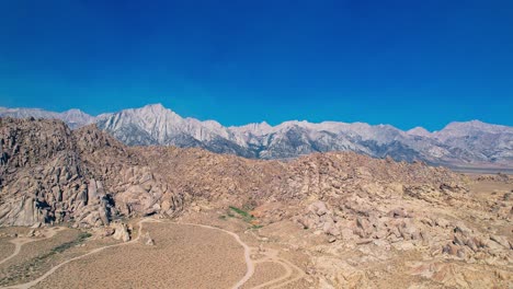 alabama hills in lone pine california 4k drone footage pull backwards over offroad trails and rock features with mount whitney in the background