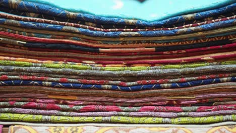 stack of colorful patterned textiles