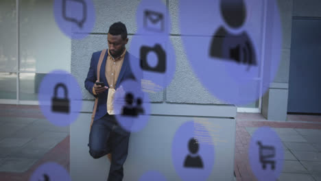 multiple digital icons against african american man using smartphone on the street