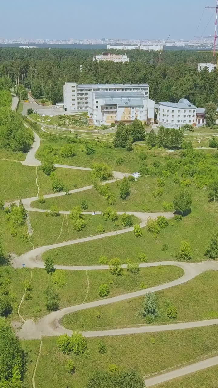 pictorial steep green hill with path of hairpin curves and newlywed couple silhouette on nice autumn day aerial view