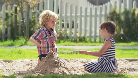 pupils at montessori school playing in sand pit at breaktime